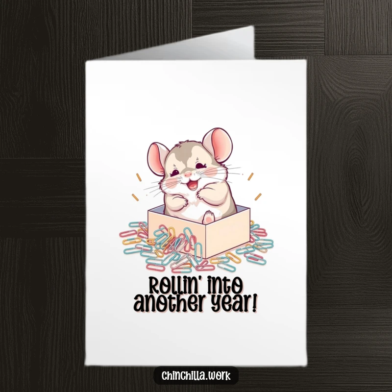 Funny Free Printable birthday card showing a chinchilla gleefully rolling in spilled paperclips, a scene of pure joy.